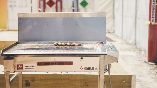 Minister for Climate Change and Sustainability Shane Rattenbury cooked sausages on a hydrogen-powered barbecue at the Canberra Institute of Technology Fyshwick campus.