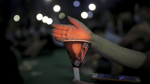 Activists defied bans to hold a candlelight vigil in Hong Kong.
