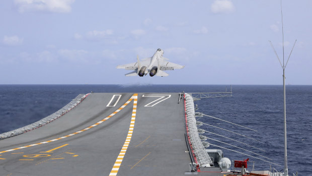A Chinese fighter jet takes off from an aircraft carrier near Taiwan in April.