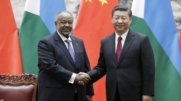 Chinese President Xi Jinping, right, shakes hands with Djibouti's President Ismail Omar Guelleh during a signing ceremony.