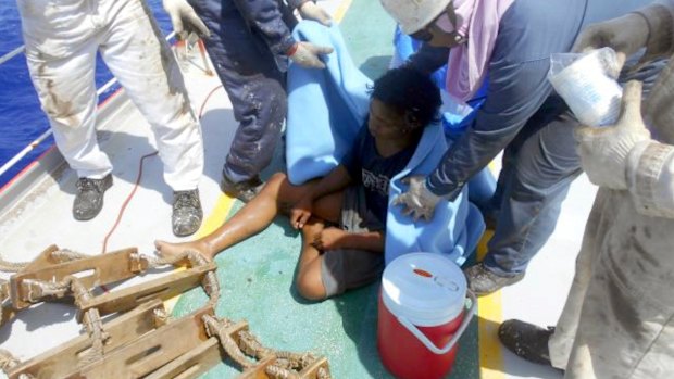 Aldi Novel Adilang on the deck of a Panamanian-flagged vessel, MV Arpeggio after being rescued.
