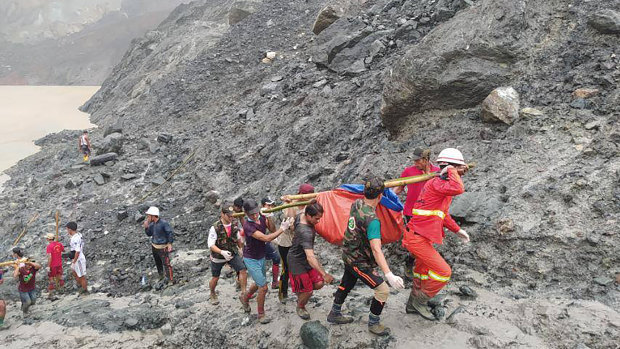 Rescue workers recover bodies after the landslide at a jade mine in Myanmar.