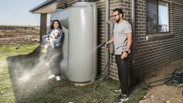Nohad and Rebecca Nasas, with their dog Ozzie, at their new house in Oran Park.