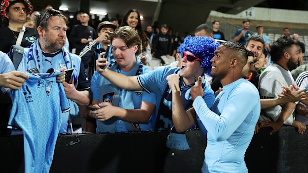 Costa is embraced by fans after his Sydney FC debut last month.