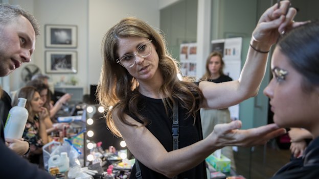 Make-up director Sarah Laidlaw shows Toni Maticevski a look for approval.