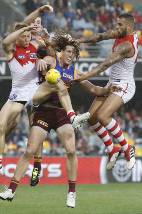 Swans and Lions compete for a loose ball.