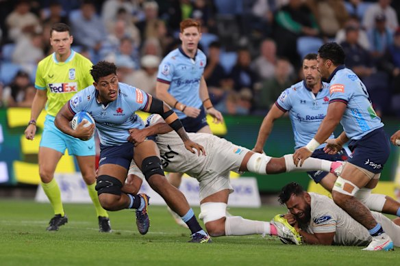 Miles Amatosero of the Waratahs is tackled.
