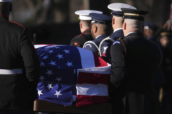 Military personnel carry the coffin of former president Jimmy Carter for the start of a six-day state funeral.