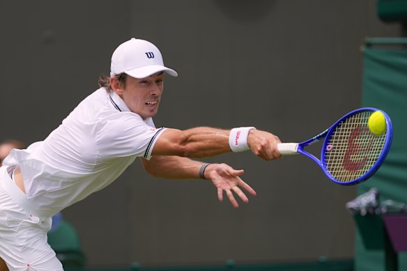 Alex de Minaur lunges for a return.