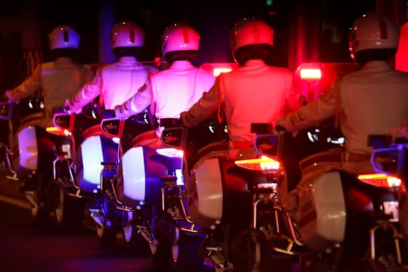 Motorcyclists accompany US President Donald Trump's convoy leaving the airport in Beijing.