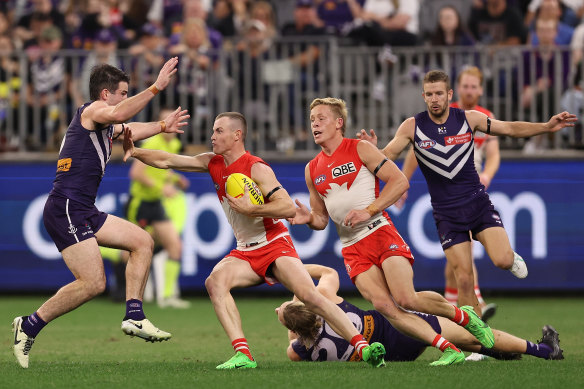 Chad Warner of the Swans fends off Andrew Brayshaw of the Dockers.