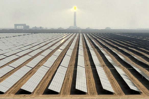 Solar panels at Mohammed bin Rashid Al Maktoum Solar Park and its solar tower in Dubai.