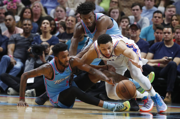 Ben Simmons battles with Miami Heat forwards Derrick Jones Jr. (No. 5) and Jimmy Butler, rear, during the Heat's win over the Philadelphia 76ers.