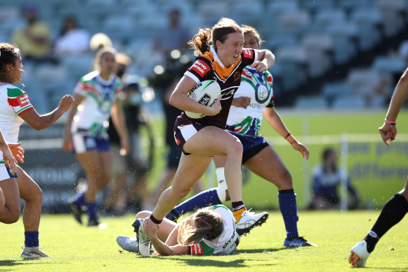 Brisbane's Tamika Upton breaks the Warriors defensive line for one of her three tries on Saturday.