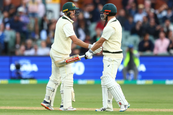 Marnus Labuschagne of Australia celebrates reaching a half century with Travis Head of Australia.