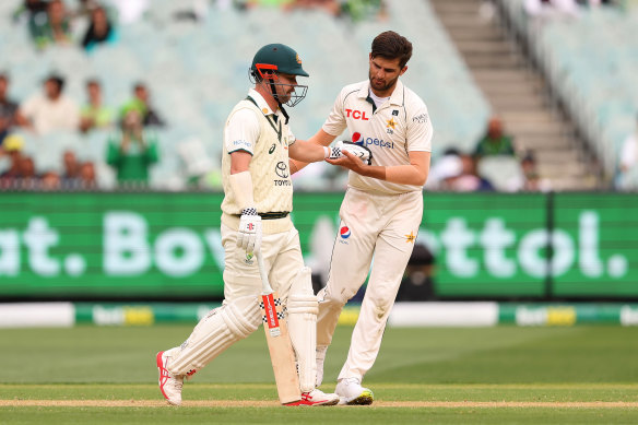 Shaheen Afridi of Pakistan checks on Travis Head of Australia after striking him with the ball.