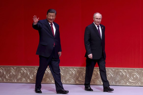 Russian President Vladimir Putin and Chinese President Xi Jinping leave a concert marking the 75th anniversary of the establishment of diplomatic relations between Russia and China.