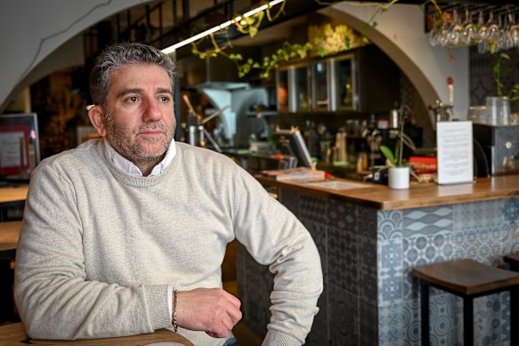 Sam Aldemir, owner of De Barcelona cafe in Hawthorn, has taken e-bike concerns into his own hands, setting up his own delivery platform and handing leaflets out to riders.
