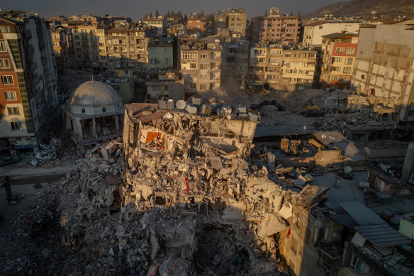 A destroyed mosque is seen amid the rubble of destroyed buildings on in Hatay, Turkey on Monday.