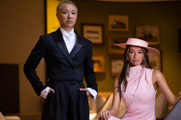 Writer Jess Ho in an E Nolan suit and VRC ambassador Demi Brereton wearing a Mossman dress and Morgan & Taylor hat, celebrating the changing dress code at Flemington for Fashions on the Field.