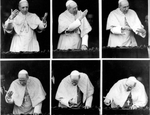 Pope Pius XII leans from a window of his summer residence at Castelgandolfo to impart his blessing in September 1956.