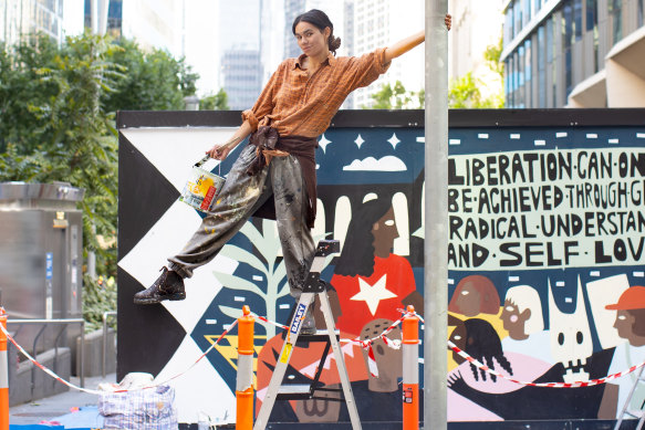Aretha Brown with her new mural in Collins Street.