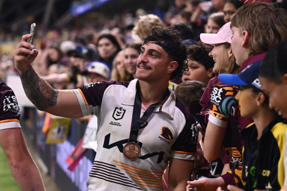 Kotoni Staggs celebrates with fans after the Brisbane Broncos defeated the North Queensland Cowboys.