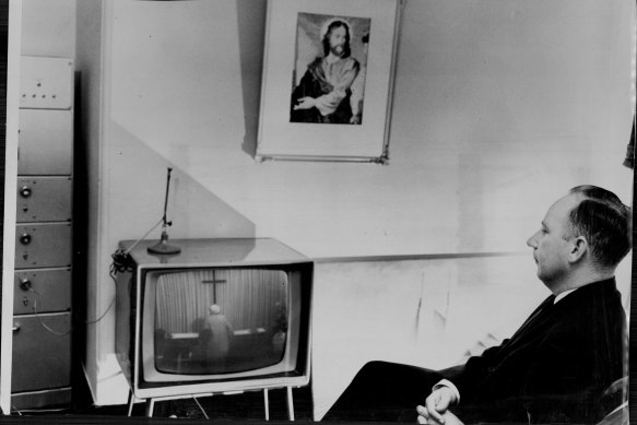 The Reverend Ted Noffs watches a closed circuit screen at the Methodist Wayside Chapel from his office, in 1964, where artist Tiiu Reissar painted him for the Archibald Prize.