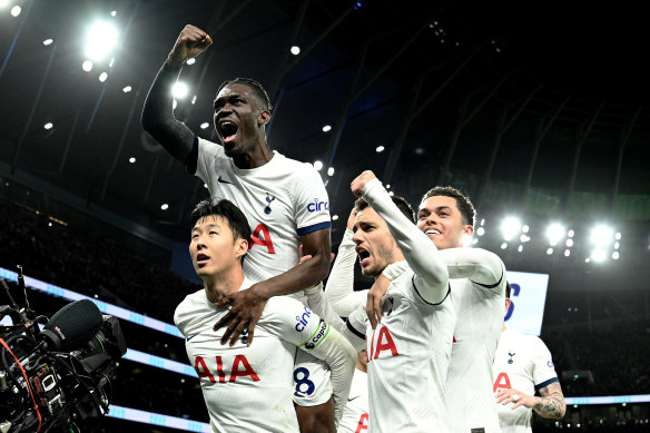 Spurs celebrate after Son Heung-min (bottom left) scores from the spot.