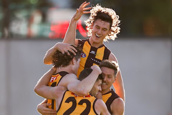 Long (top) in his time with the Hawks with then-teammates Luke Breust, Connor Macdonald and Fergus Greene.