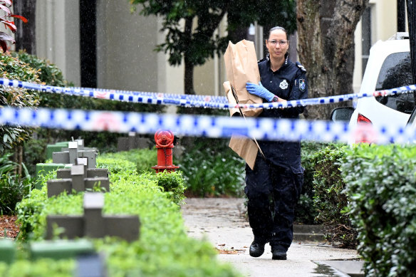 Police are seen at a crime scene in Carrara on the Gold Coast.