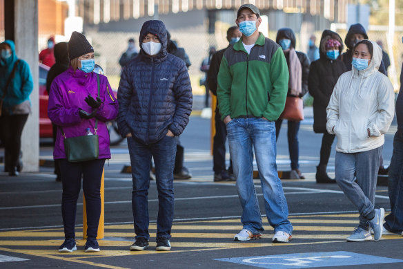 People wait in line to get a COVID-19 vaccine in Melbourne.