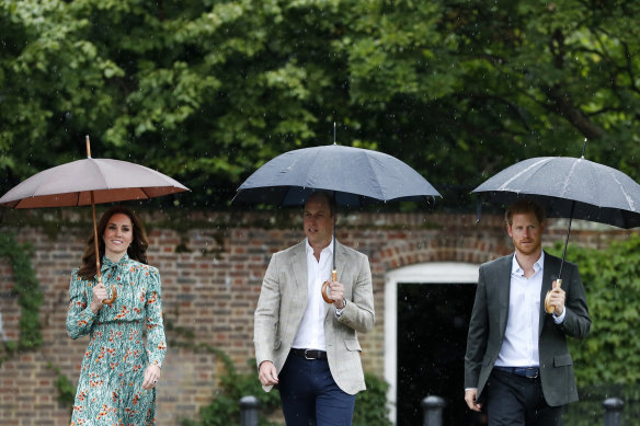Prince William, the Duchess of Cambridge and Prince Harry at the memorial garden in Kensington Palace in 2017 paying tribute to  Princess Diana on the 20th anniversary of her death.