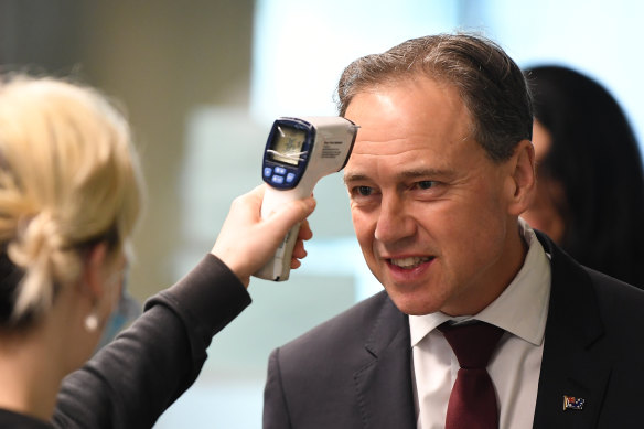 Federal Health Minister Greg Hunt has his temperature checked before touring the Royal Melbourne Hospital on Thursday.