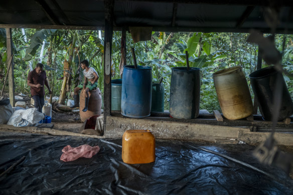 Edilberto Linares (left) and Roger Alonso Guzman Salinas at a clandestine coca lab that turns leaves into paste.