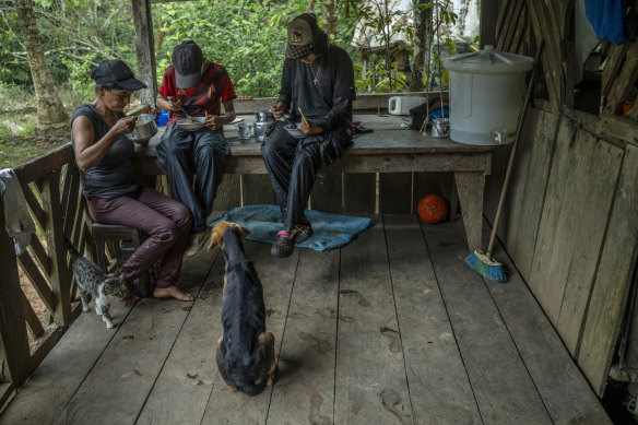 Coca harvester Yamile Hernandez (left) and her teenage children, Manuel and Valentina Patarroyo, have a breakfast that serves as part-payment for work.