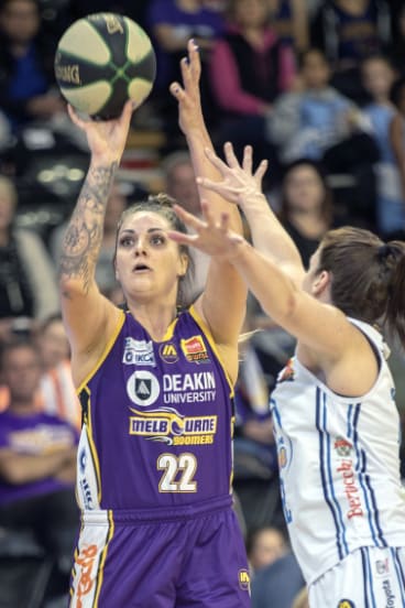 Shooting star: Boomer Cayla George fires two of her game-high 27 points over Sydney’s Belinda Snell. 