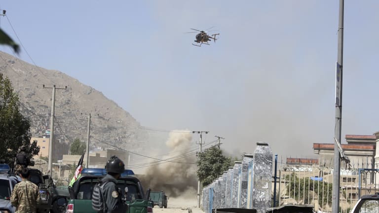 An MD 530F military helicopter targets a house where suspected attackers are hiding in Kabul, Afghanistan, on  August 21, 2018. 