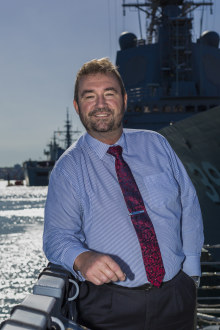 Shipbuilding is a high-tech enterprise, says Ian Irving, chief executive of the Naval Shipbuilding College. pictured  in front of HMAS Hobart during a visit to Garden Island.