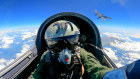 In this photo released by Xinhua News Agency, a Chinese fighter jet pilot takes part in military drills around Taiwan.