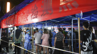 People line up for COVID-19 tests at a testing station in Nanjing in eastern China’s Jiangsu Province.
