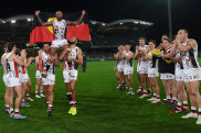 ADELAIDE, AUSTRALIA - MAY 21: Bradley Hill of the Saints is chaired off by Ben Long of the Saints and Paddy Ryder of the Saints for his 200th game after  the round 10 AFL match between the Adelaide Crows and the St Kilda Saints at Adelaide Oval on May 21, 2022 in Adelaide, Australia. (Photo by Mark Brake/Getty Images)