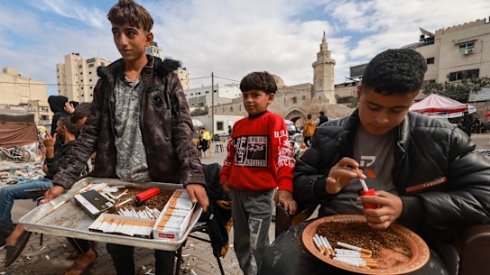 Palestinian youths sell cigarettes on a main square in Khan Younis in November.