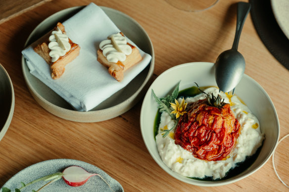 Dishes such as dried tomato with smoked stracciatella (right) are designed around the garden and a large wall of preserves.