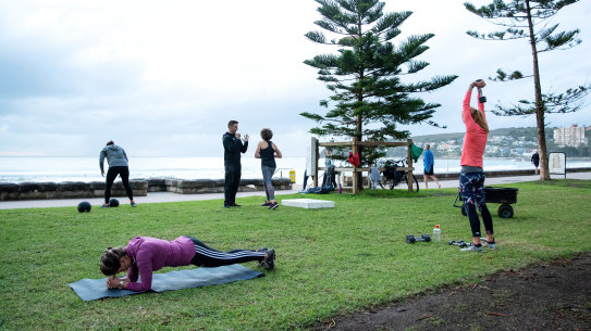 SYDNEY, AUSTRALIA - MAY 15: People participate in an outdoor bootcamp session hosted by Manly Beach Health Club at Manly Beach on May 15, 2020 in Sydney, Australia. Restrictions put in place in response to the COVID-19 outbreak have been eased in New South Wales as of today, with social distancing measures relaxed in response to Australia's declining number of confirmed coronavirus cases. From Friday 15 May cafes and restaurants along with pub and club dining areas are allowed to reopen for up to 10 patrons at a time. Outdoor gatherings of up to 10 people are now also permitted, while outdoor gyms, playgrounds, swimming pools can also open. Up to 10 guests can attend a wedding while 20 mourners are permitted for an indoor funeral, or 30 can attend if the service is outdoors. Religious gatherings and places of worship can have 10 worshipers at one time, while people are permitted to have up to five visitors in their homes at any one time. (Photo by Cameron Spencer/Getty Images)