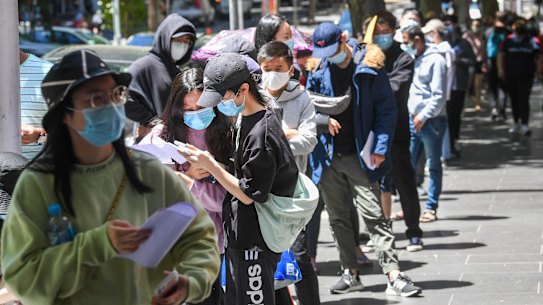 Melburnians queue for testing on Russell Street in the CBD on Monday.