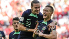 Mitchell Duke celebrates with Jackson Irvine after scoring a goal.