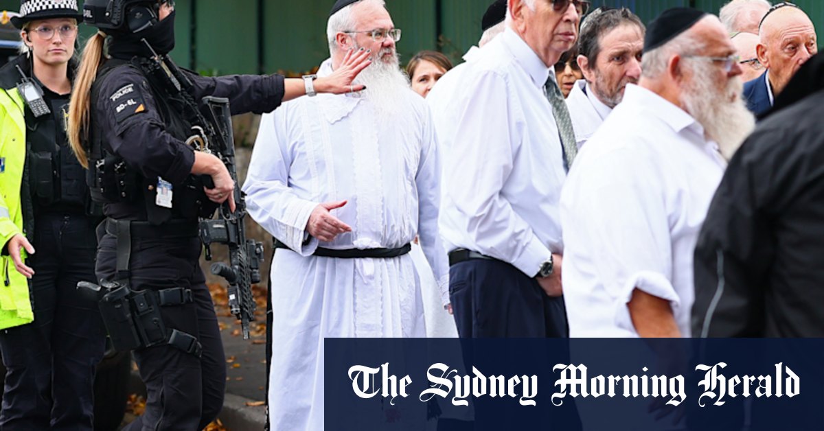 His robe stained with blood, a rabbi led his defiant Manchester congregation in prayer
