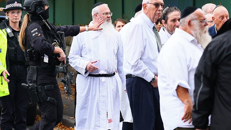 His robe stained with blood, a rabbi led his defiant Manchester congregation in prayer