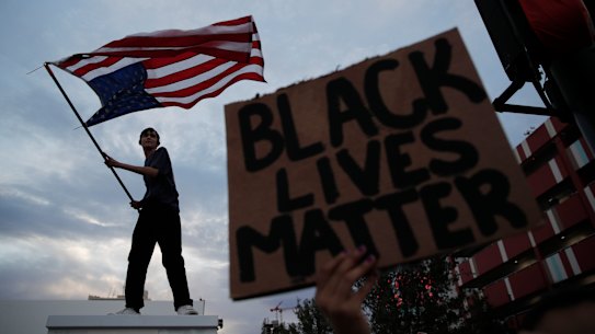 Protesters rally Saturday, May 30, 2020, in Las Vegas, over the death of George Floyd, a black man who was in police custody in Minneapolis. Floyd died after being restrained by Minneapolis police officers on Memorial Day. (AP Photo/John Locher)
